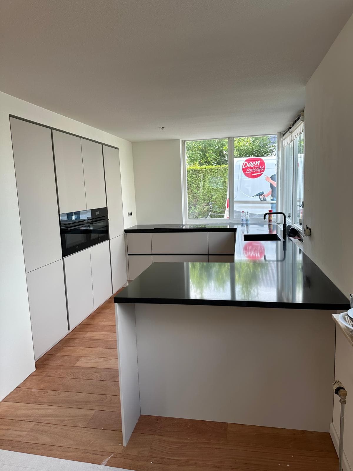 Zwarte hoogglans keuken met marmeren werkblad
